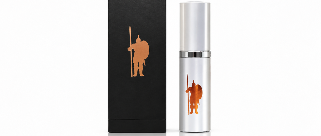 LaCroy IMPI Original men's pheromone cologne in a silver spray bottle with copper warrior emblem, displayed beside its black retail box against a white studio background.