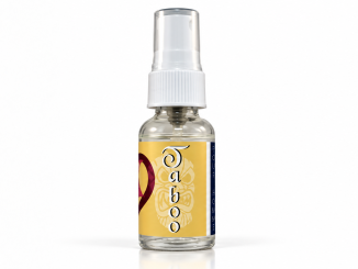 PheromoneXS Taboo XS pheromone bottle with transparent cap, white applicator, golden-yellow label, vertical Taboo lettering, and burgundy accents against a clean white studio background.