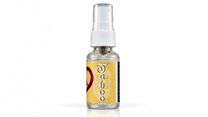 PheromoneXS Taboo XS pheromone bottle with transparent cap, white applicator, golden-yellow label, vertical Taboo lettering, and burgundy accents against a clean white studio background.