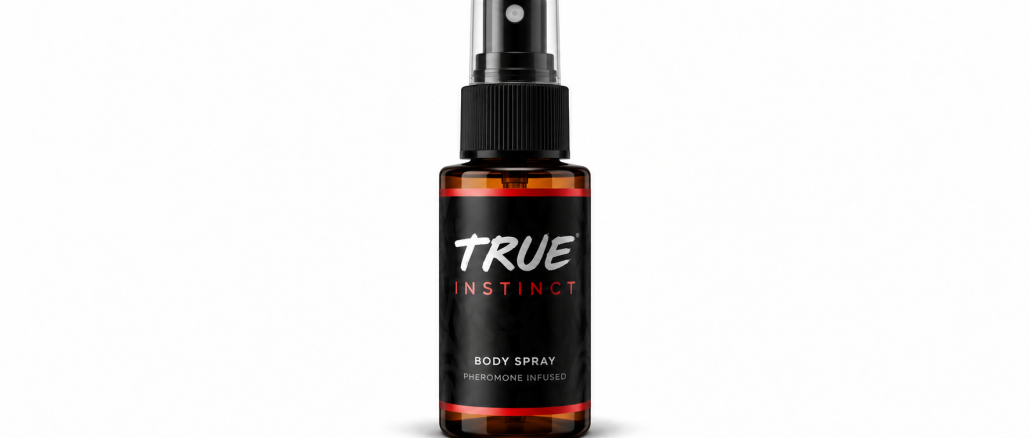 TRUE Instinct men's pheromone body spray in an amber bottle with a black label, white TRUE logo, red INSTINCT lettering, and transparent spray cap against a white background.