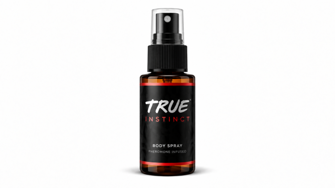 TRUE Instinct men's pheromone body spray in an amber bottle with a black label, white TRUE logo, red INSTINCT lettering, and transparent spray cap against a white background.